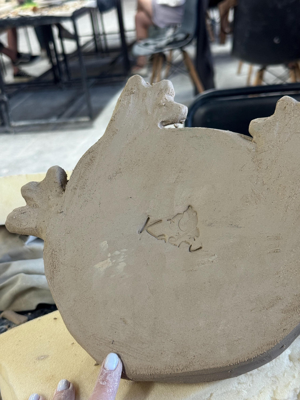 Bottom of the frog sculpture showing handmade Kaeru logo
