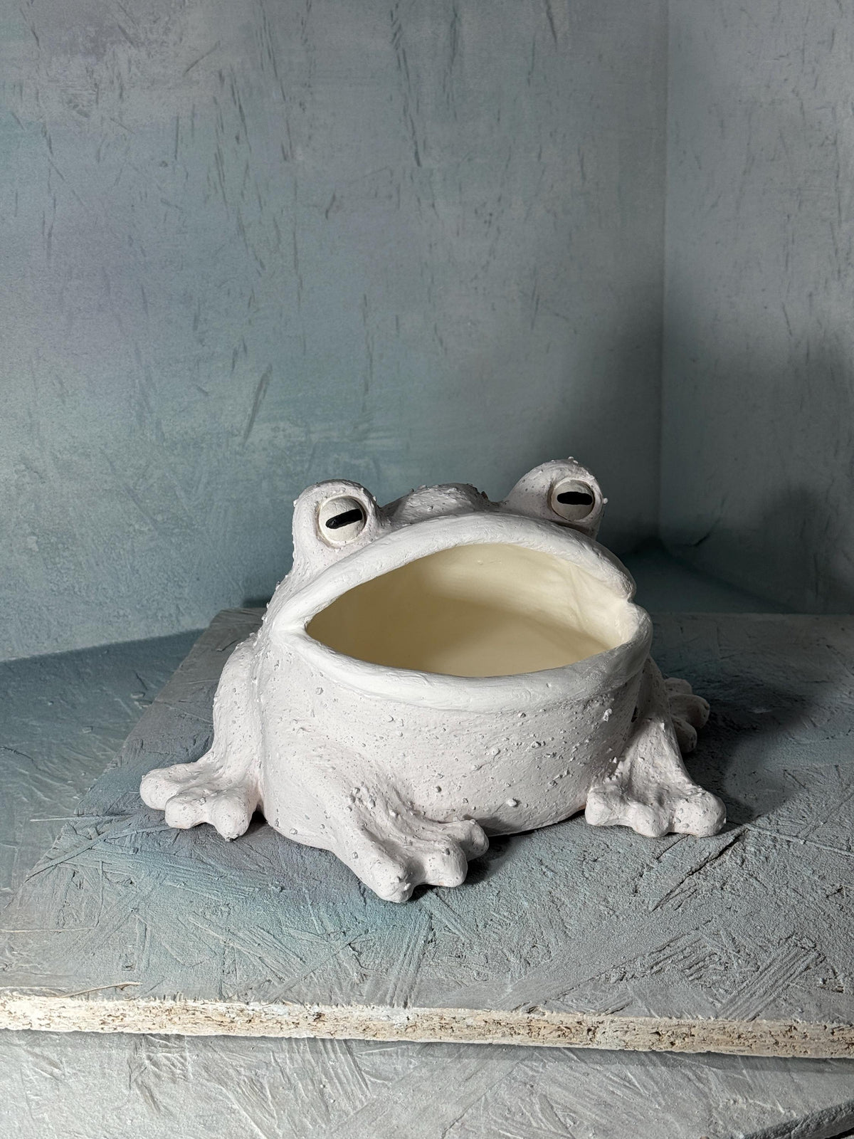 Unglazed ceramic frog container before glazing