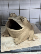 Raw clay frog sculpture before first firing